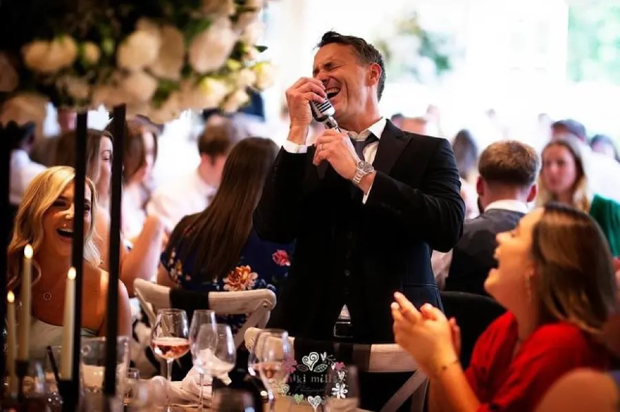 A packed wedding room during the act